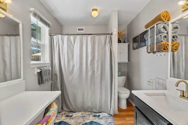 a bathroom with a sink toilet and shower