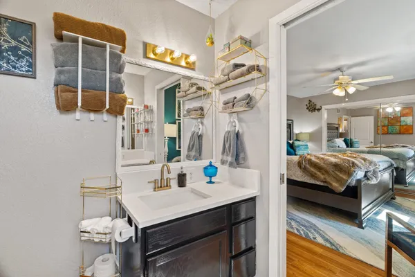 a bedroom with a bed and a mirror