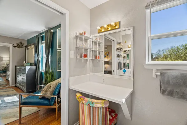 a living room with furniture a flat screen tv and a floor to ceiling window