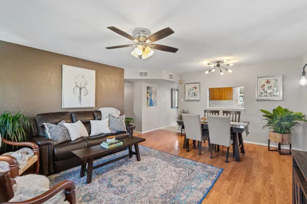 a living room with furniture and wooden floor