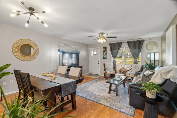 a living room with furniture and a chandelier