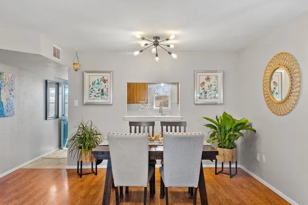 a view of a dining room with furniture and wooden floor