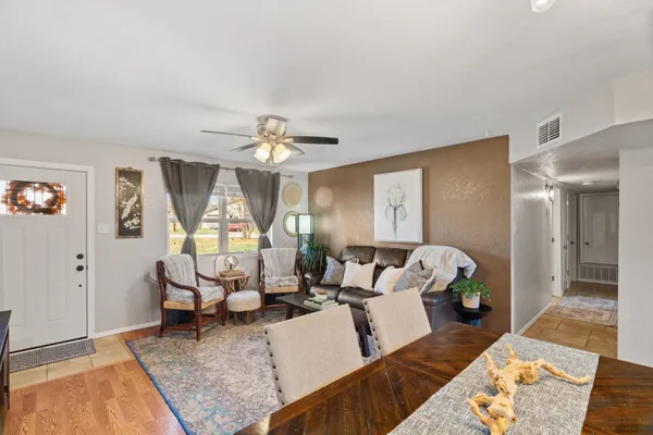 a living room with furniture and a chandelier