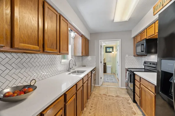 a kitchen with stainless steel appliances granite countertop a sink stove and cabinets