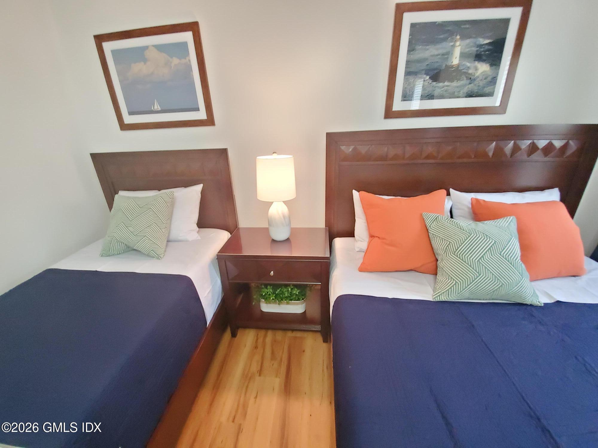 92 Valley Road, Unit B Cos Cob, CT 06807 - Photo 16 of 46 a bedroom with a bed and a painting on the wall