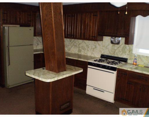 20 Rodney Road East Brunswick, NJ 08816 - Photo 3 of 6 a kitchen with a refrigerator and a stove