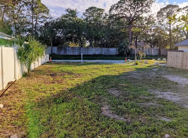 a view of yard with swimming pool and trees