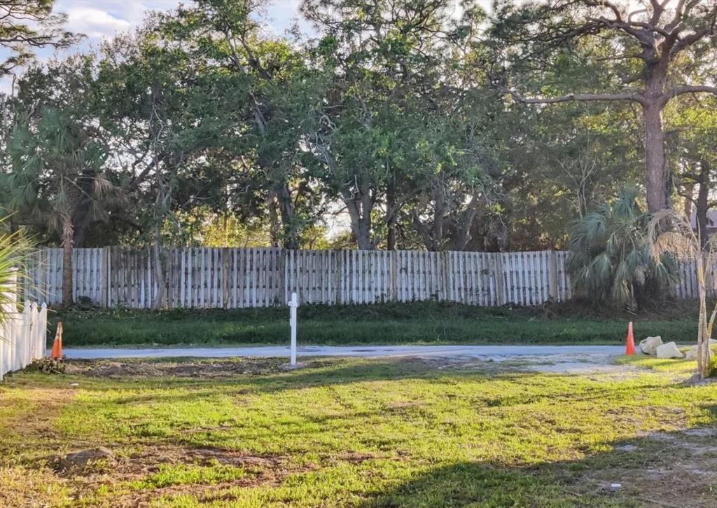 0 Benson Street Sarasota, FL 34231 - Photo 8 of 12 a view of swimming pool with wooden fence and trees in the background