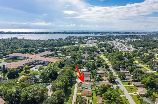 an aerial view of a houses with a swimming pool