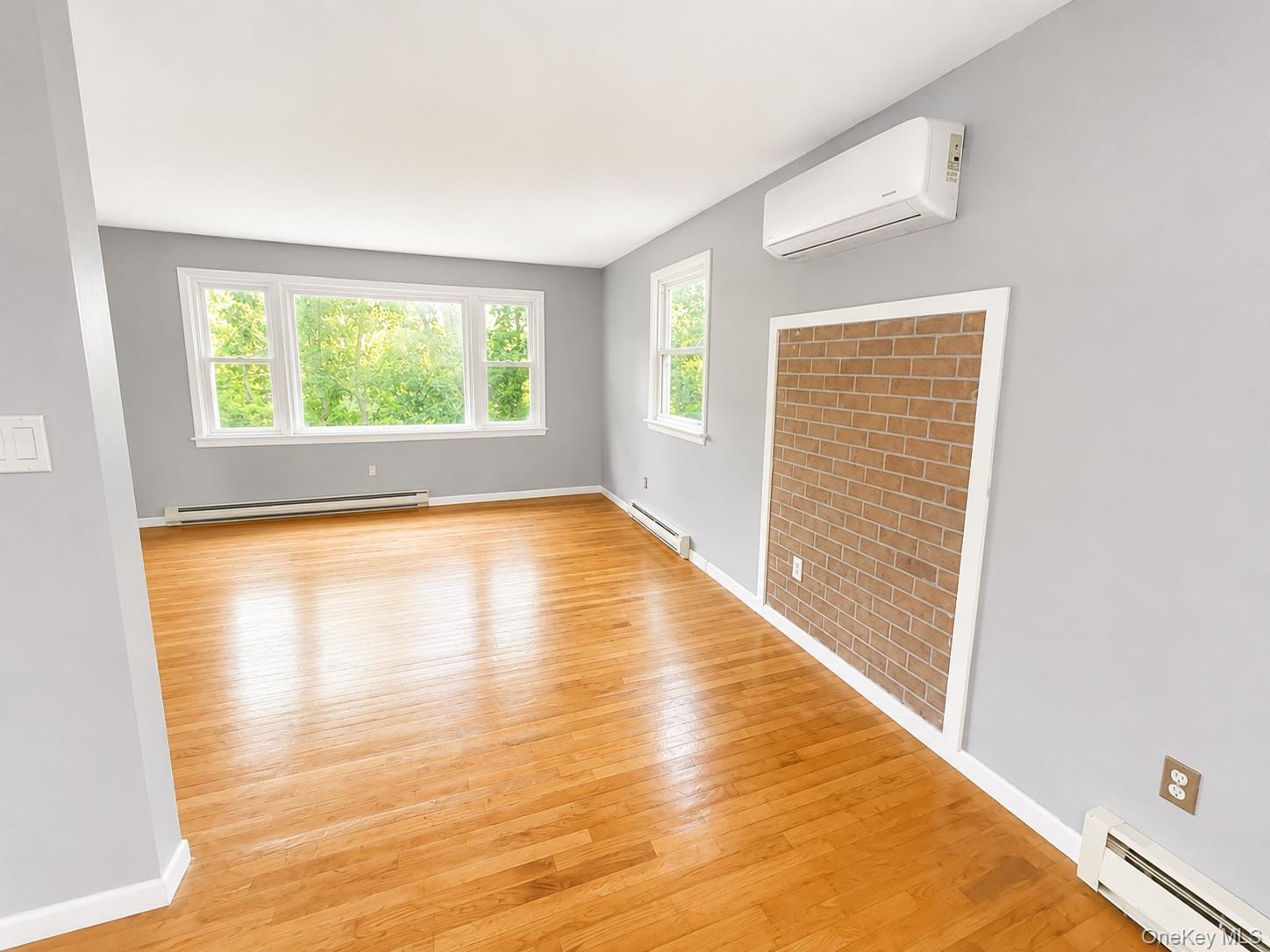43 Glenmere Homesites Road, Unit 2F Florida, NY 10921 - Photo 11 of 15 Bright room featuring hardwood flooring and light gray walls