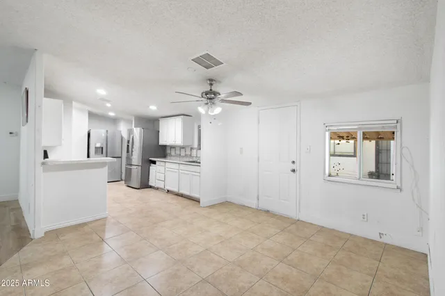 a view of a room with a ceiling fan
