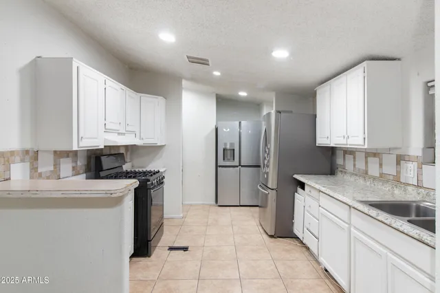 a view of a house with wooden fence