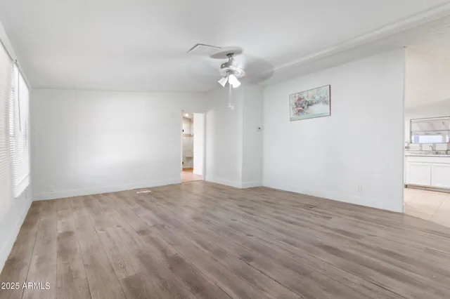 a kitchen with white cabinets a sink a window and stainless steel appliances