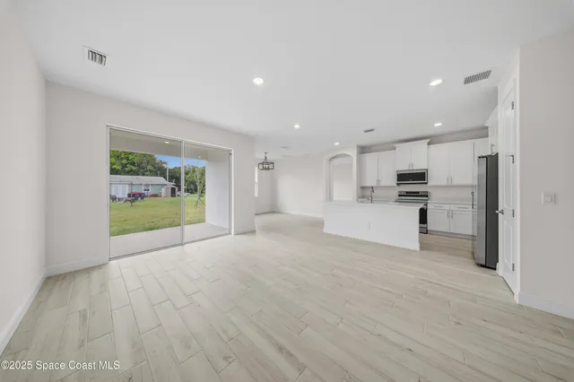 a view of a kitchen with a sink and a refrigerator