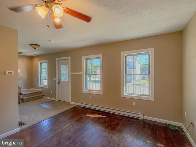 a kitchen with a table chairs refrigerator and microwave