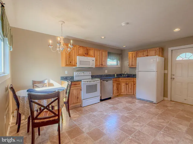 a open kitchen with stainless steel appliances granite countertop a stove and a sink