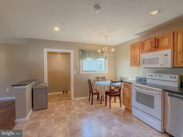a kitchen with stainless steel appliances granite countertop cabinets and a refrigerator