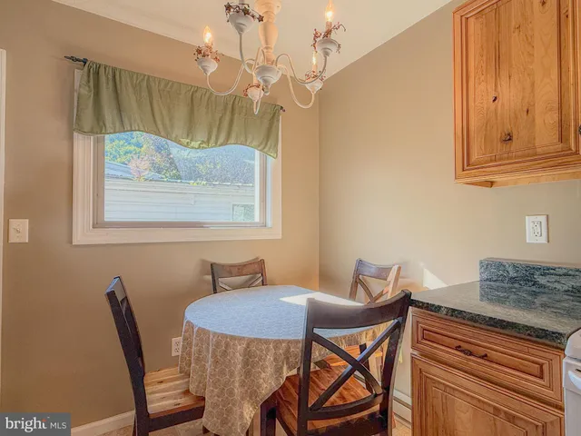 a view of kitchen island with granite countertop wooden cabinets