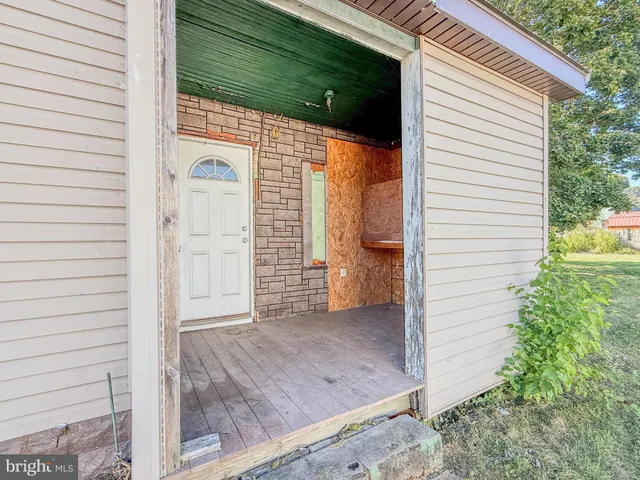 a view of a house with a yard and wooden fence