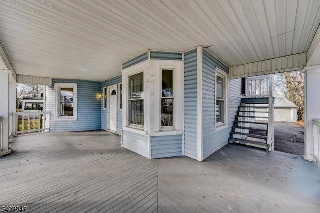 a view of front door of house with stairs