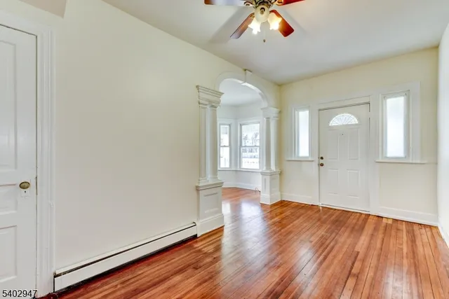 wooden floor in an empty room with a window