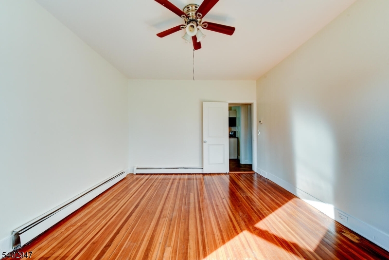 946 West 7th Street, Unit 1 Plainfield, NJ 07063 - Photo 6 of 14 a view of an empty room with wooden floor