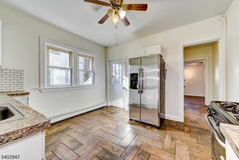 946 West 7th Street, Unit 1 Plainfield, NJ 07063 - Photo 7 of 14 a view of a livingroom with wooden floor and a kitchen space