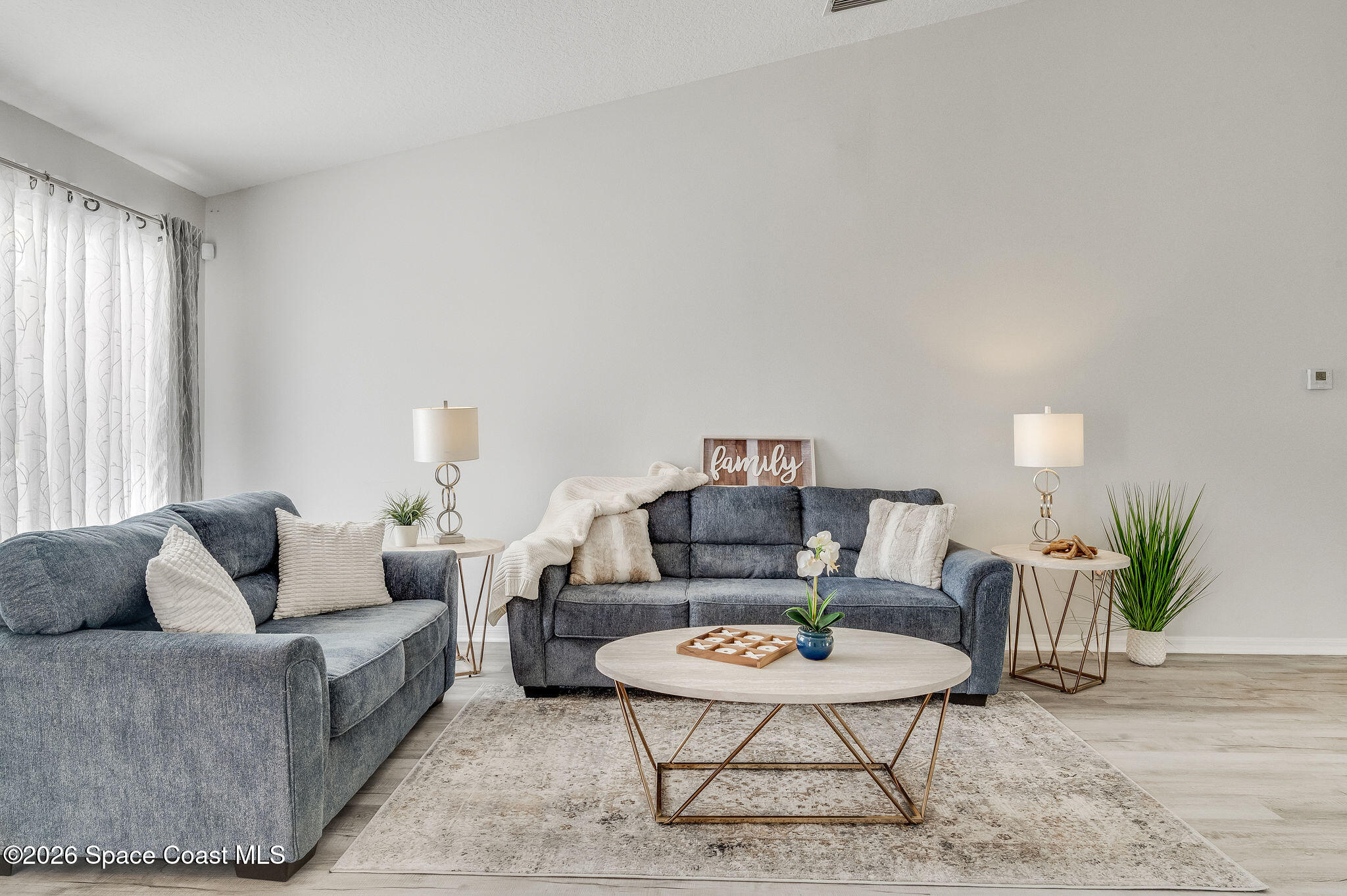 428 Wenthrop Circle Rockledge, FL 32955 - Photo 3 of 58 a living room with furniture and a potted plant