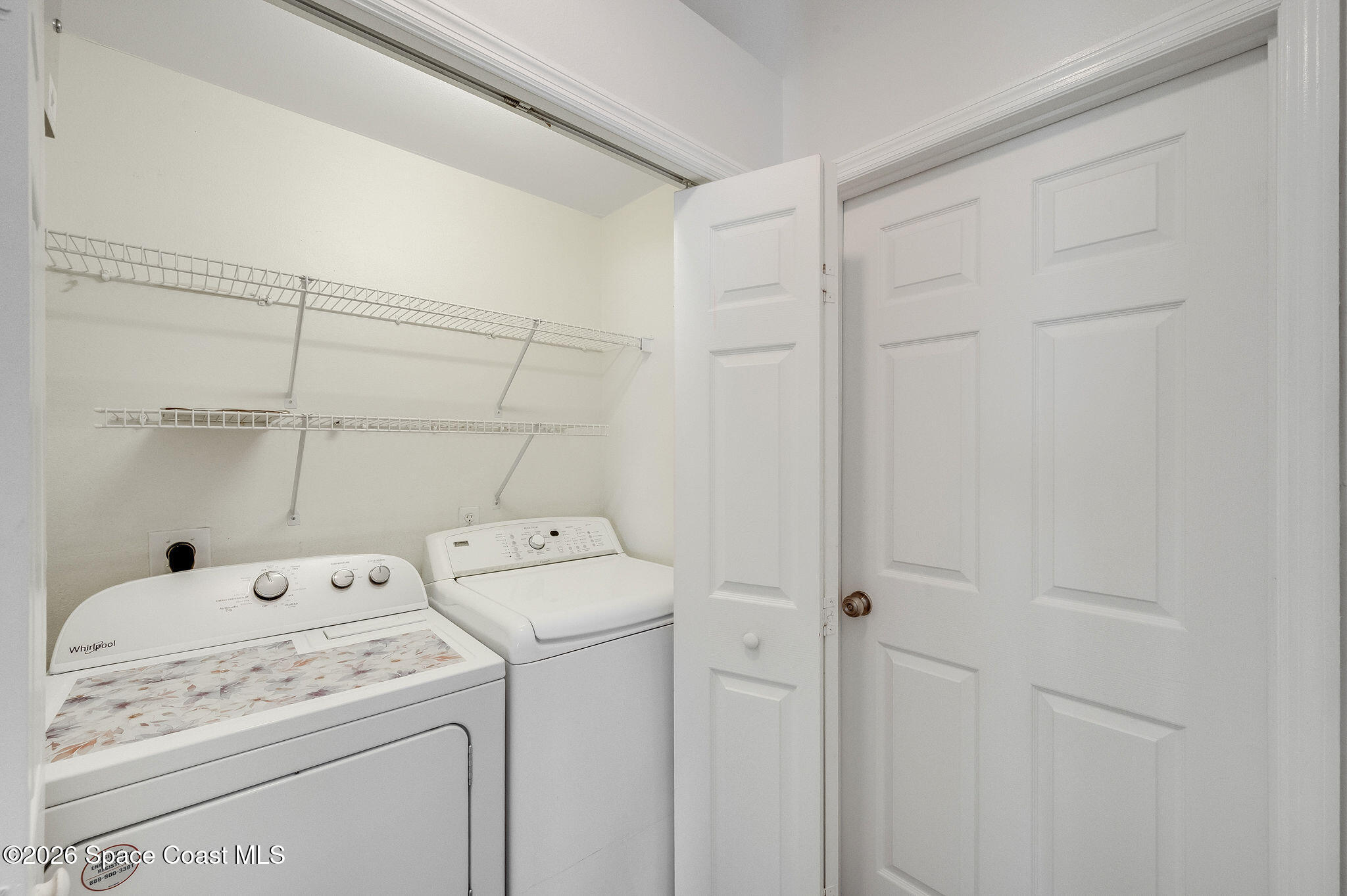 428 Wenthrop Circle Rockledge, FL 32955 - Photo 44 of 58 a view of washer and dryer with bathroom in the background