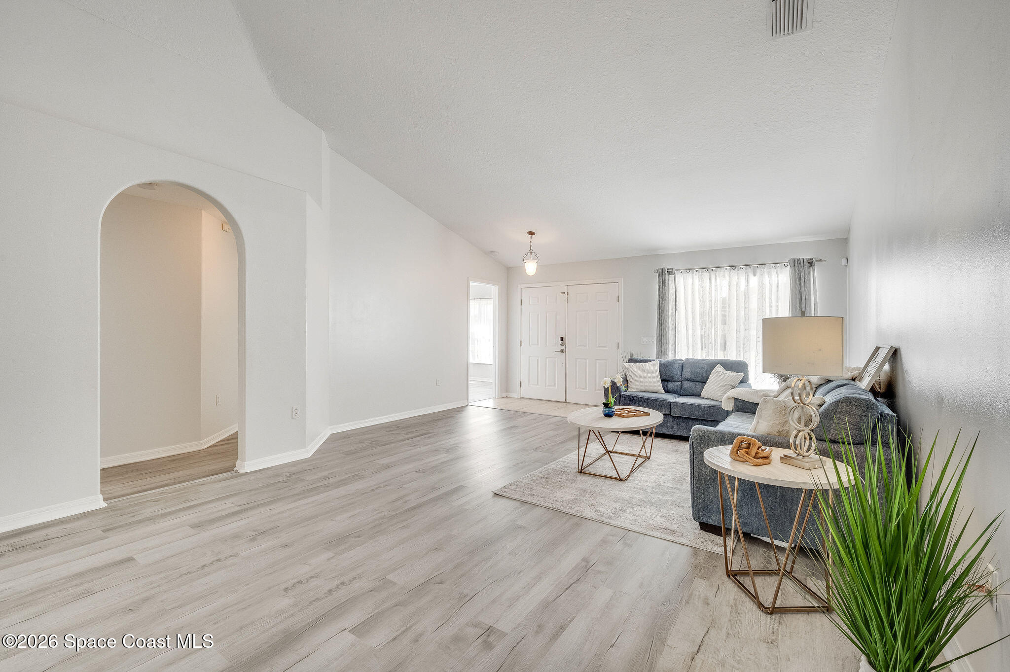 428 Wenthrop Circle Rockledge, FL 32955 - Photo 8 of 58 a living room with furniture a wooden floor and a potted plant