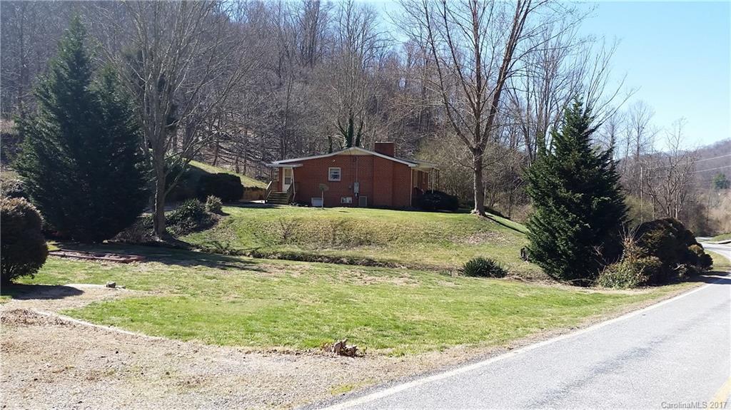 502 Wilson Cove Road Canton, NC 28716 - Photo 2 of 18 a view of a yard with an tree