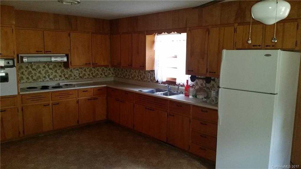 502 Wilson Cove Road Canton, NC 28716 - Photo 14 of 18 a kitchen with a sink cabinets and a refrigerator