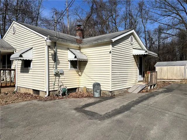 a view of a white house with a yard and garage