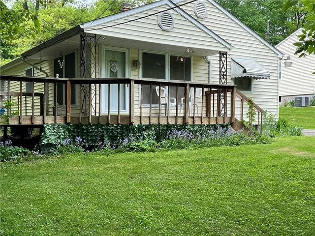 a view of a house with garden and backyard