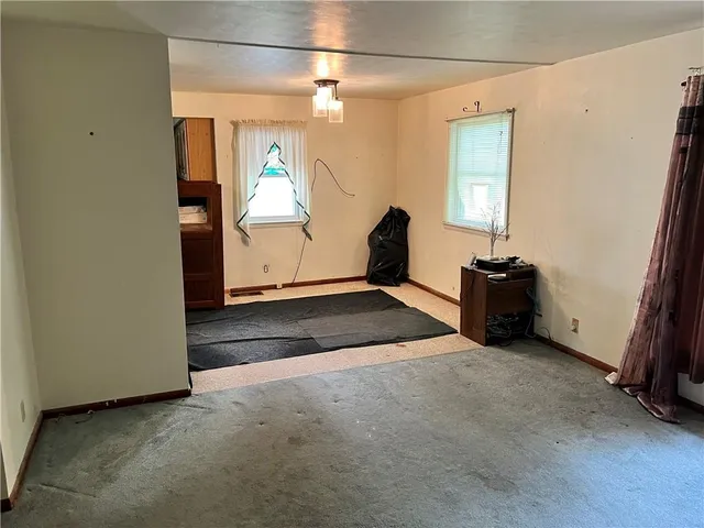 a view of an empty room with windows