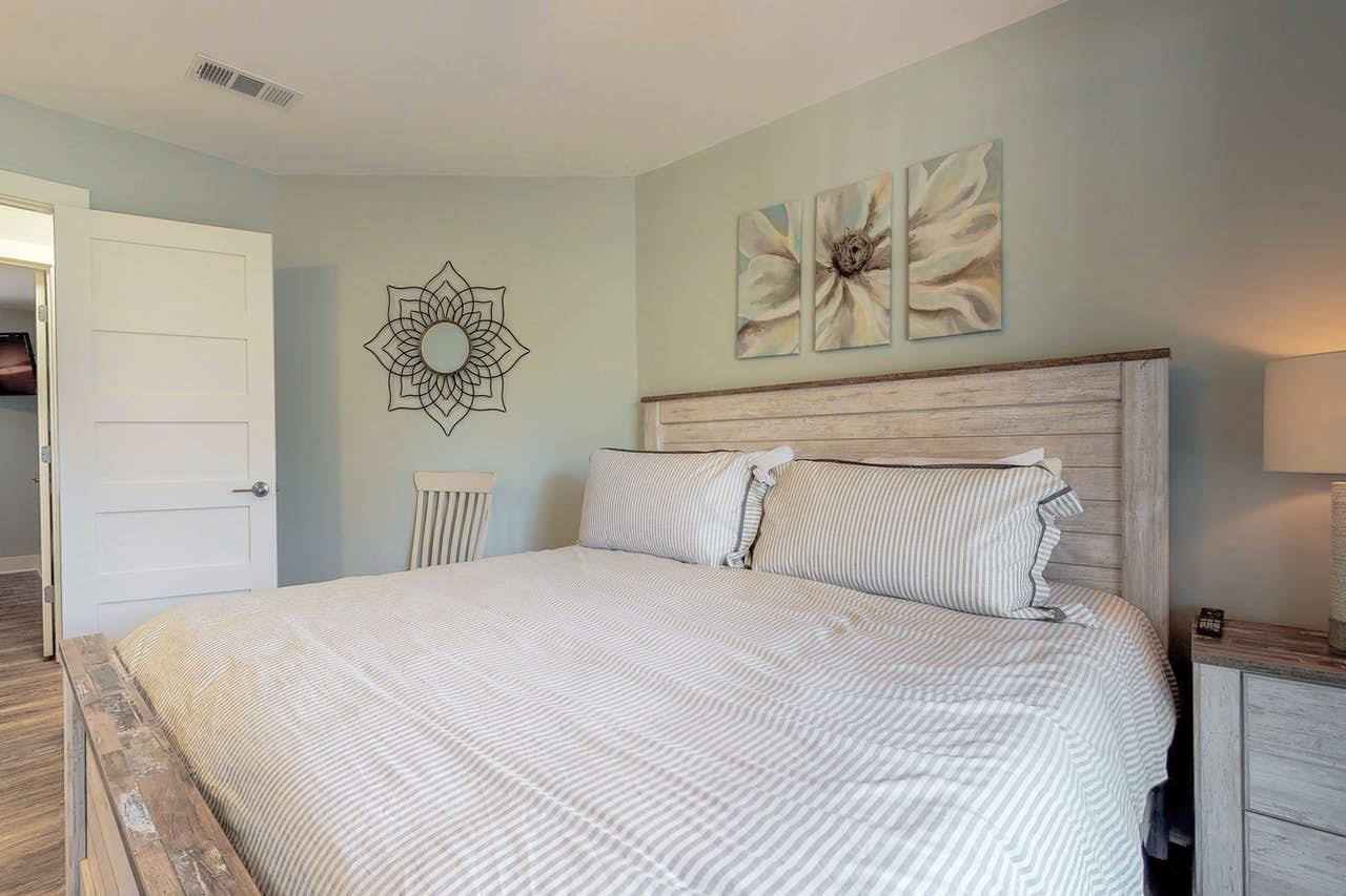 3799 East County Highway 30A, Unit F13 Santa Rosa Beach, FL 32459 - Photo 12 of 30 a bedroom with a bed and wall painting