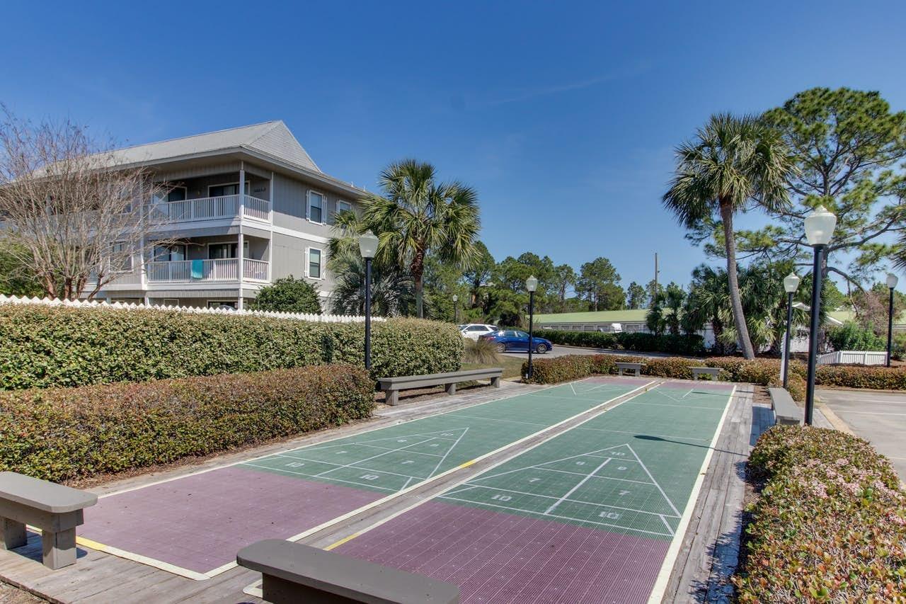 3799 East County Highway 30A, Unit F13 Santa Rosa Beach, FL 32459 - Photo 28 of 30 a view of a tennis ground with large trees