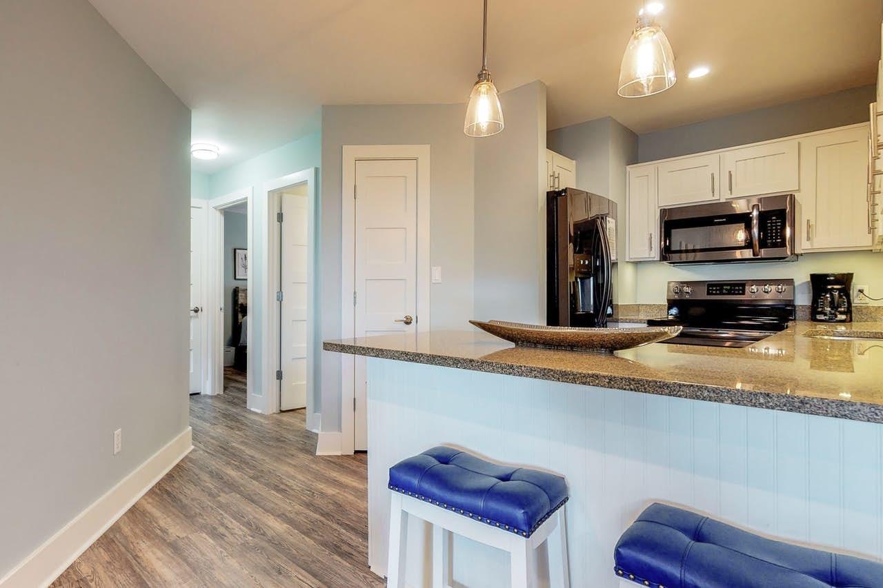 3799 East County Highway 30A, Unit F13 Santa Rosa Beach, FL 32459 - Photo 6 of 30 a view of kitchen with stainless steel appliances granite countertop a sink a stove and a refrigerator