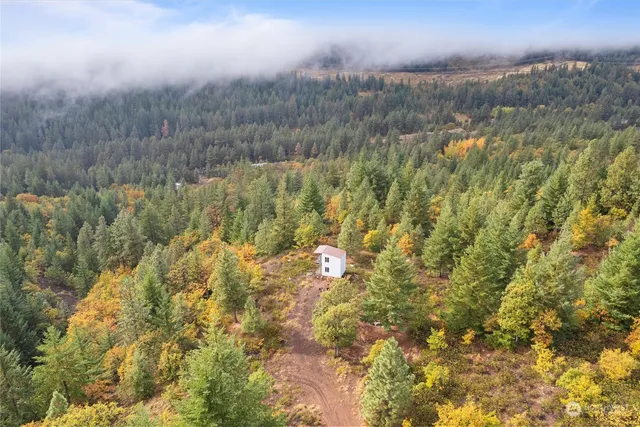 a view of a lake and green valley
