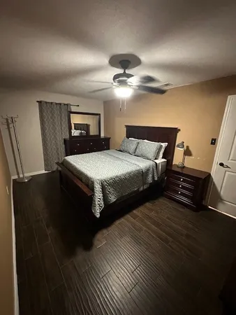 a bedroom with bed and a chandelier