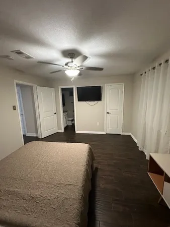 a bedroom with a bed and a chandelier