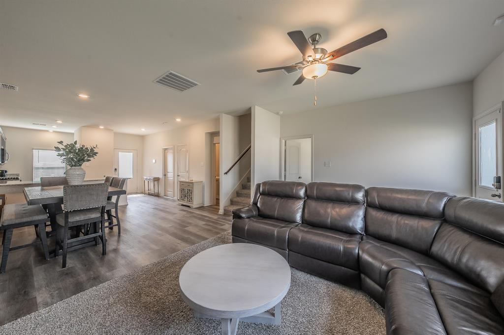 8125 White Sulphur Road Ponder, TX 76259 - Photo 10 of 38 Open-concept living space featuring wood-finish flooring, a ceiling fan with integrated lighting, recessed ceiling lights, and painted neutral walls