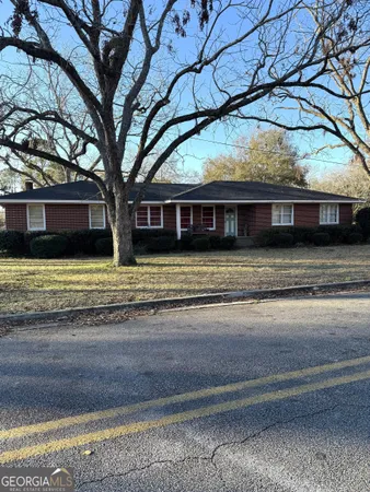 a view of a house with a large tree