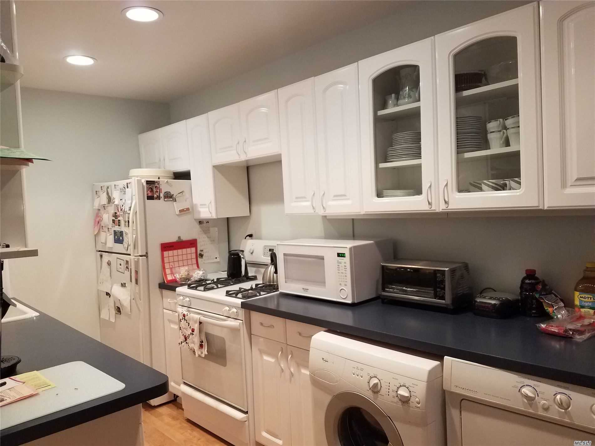 a kitchen with cabinets and appliances