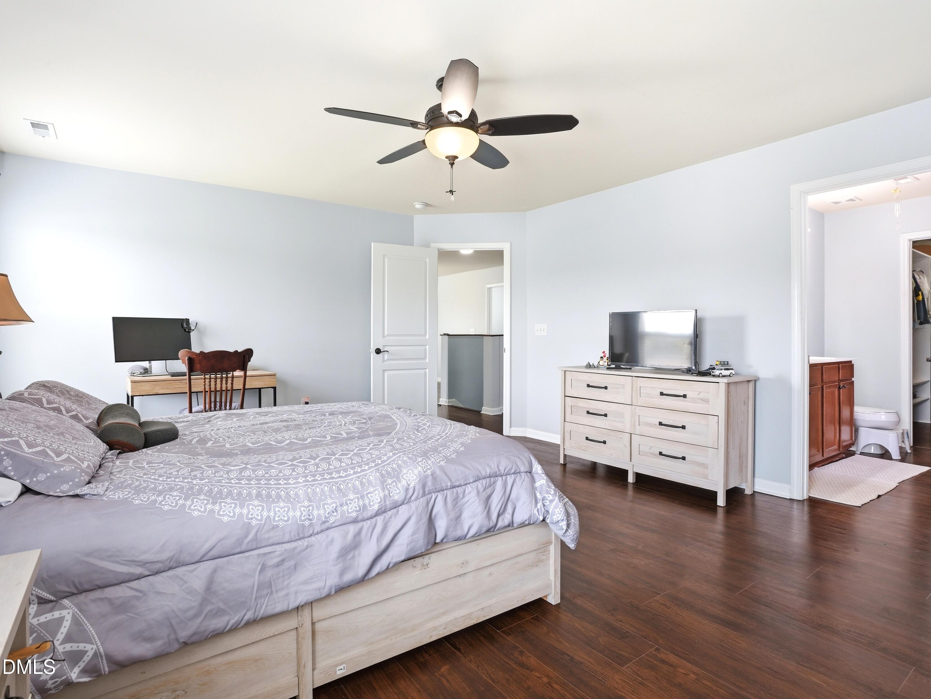 8128 Hovingham Way Raleigh, NC 27616 - Photo 16 of 40 a bedroom with a bed and wooden floor