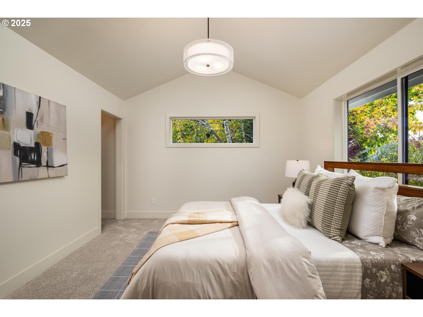 2624 North Kilpatrick Street Portland, OR 97217 - Photo 21 of 34 a bedroom with a bed and a chandelier
