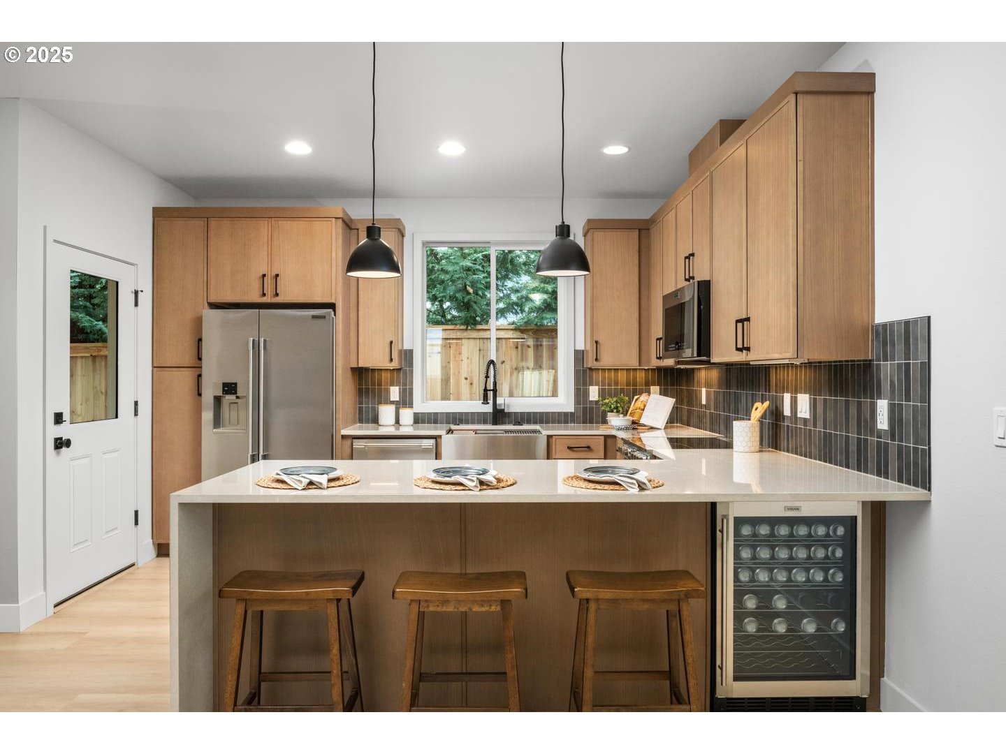 2624 North Kilpatrick Street Portland, OR 97217 - Photo 9 of 34 a kitchen with kitchen island granite countertop a sink cabinets and stainless steel appliances