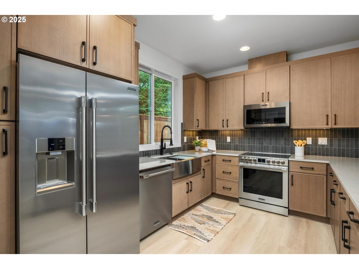 2624 North Kilpatrick Street Portland, OR 97217 - Photo 10 of 34 a kitchen with stainless steel appliances granite countertop a refrigerator a stove and a sink