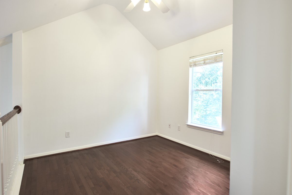 918 Cohn Street Houston, TX 77007 - Photo 18 of 32 an empty room with wooden floor and windows