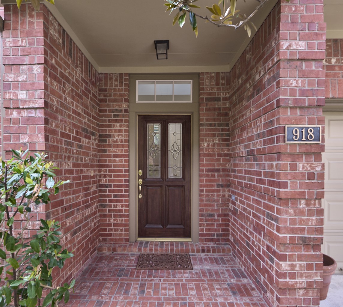 918 Cohn Street Houston, TX 77007 - Photo 26 of 32 a brick building with a window and potted plants